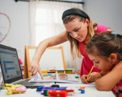 Education concept, little girl studying with friendly young home tutor during private lesson