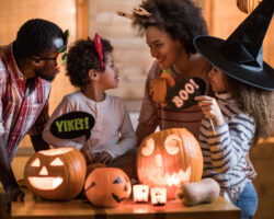 Happy family talking while enjoying in Halloween at home.