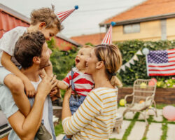 Photo of a happy family celebrating Fourth of July in their yard