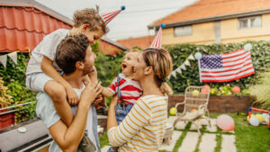 Photo of a happy family celebrating Fourth of July in their yard