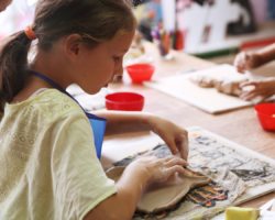 Girl in yellow shirt doing pottery