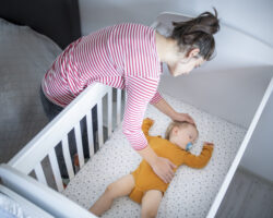 Nanny putting a baby boy to sleep.