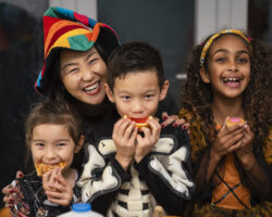 Nanny and kids eating healthy snacks they made together.