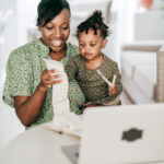 Mother and daughter reviewing finances together for nanny taxes