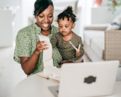 Mother and daughter reviewing finances together for nanny taxes