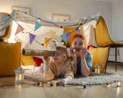 Nanny and child building a fort and doing crafts together