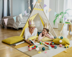 A governess and child play inside a cozy indoor tent with educational toys, turning learning into fun that doesn’t feel like homework.