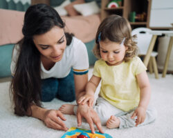 Nanny and a little girl spending time together at home.