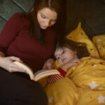 Nanny reading a book for a kid